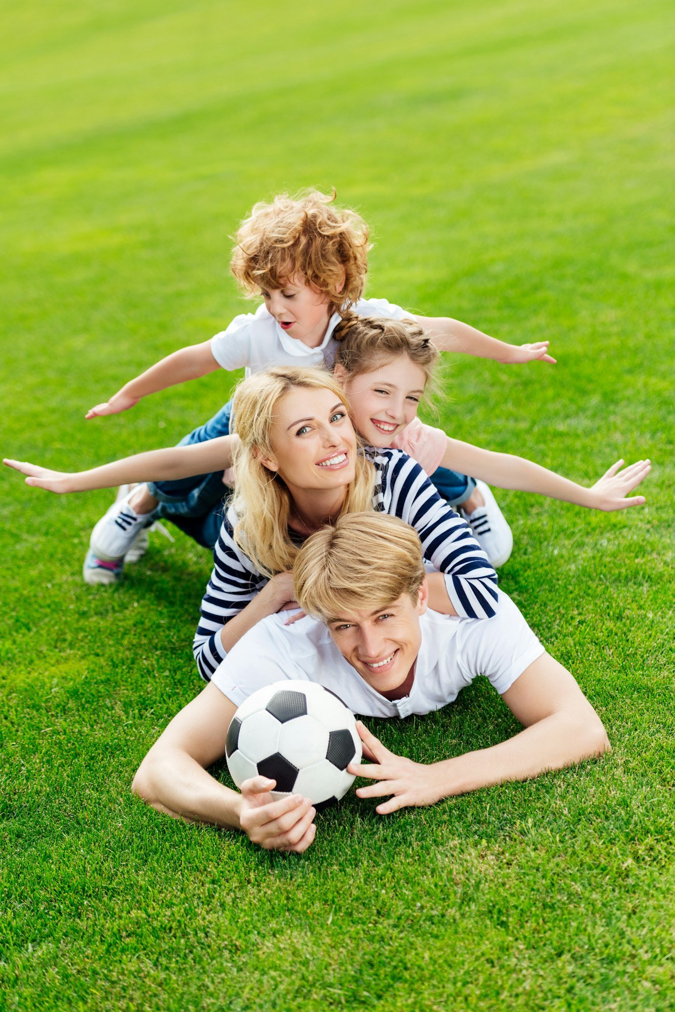 Family enjoying a healthy lawn -- Schwinger Lawn Service, Stuart Iowa