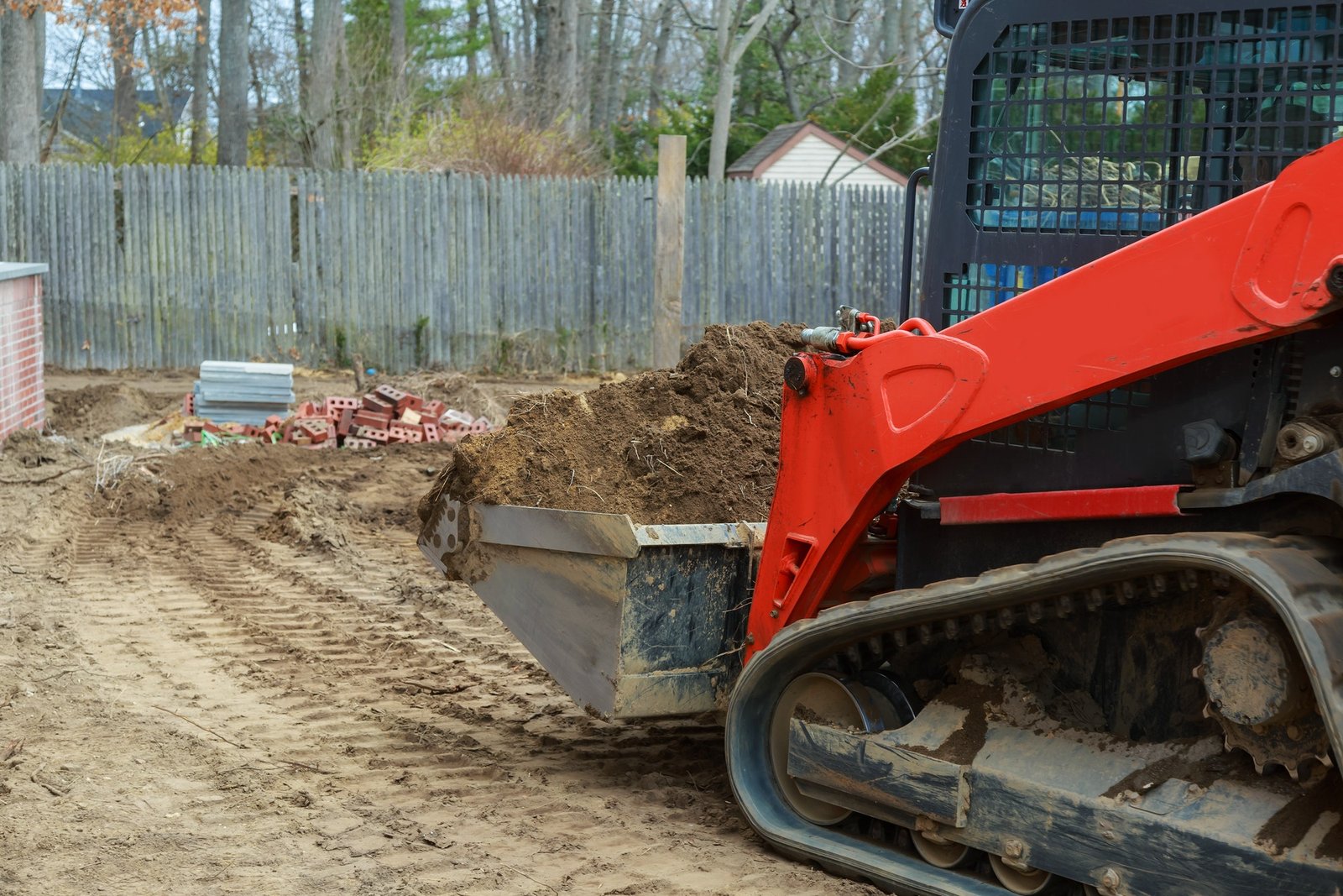 Mini bulldozer leveling and grading soil in Iowa