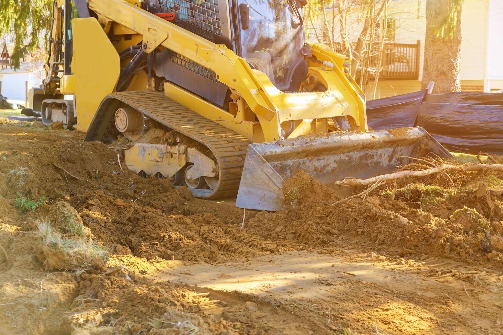 Mini bulldozer doing grading and landscaping work in Stuart, Iowa
